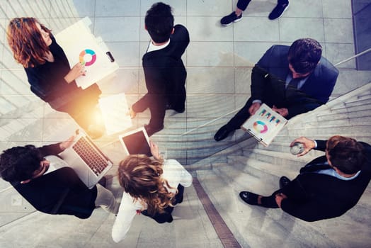 Team of people works together on company statistics in office. Shooted from above. Concept of teamwork and partnership. double exposure