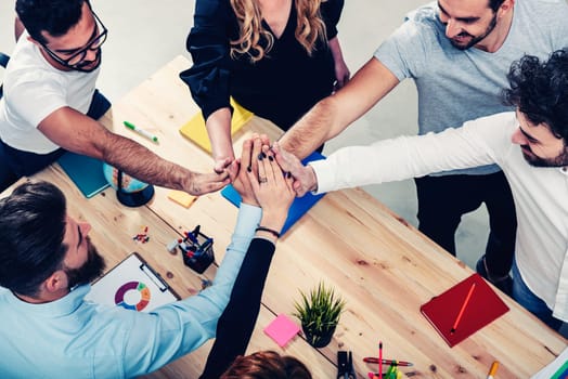 Business people putting their hands together in office. Concept of integration, teamwork and partnership
