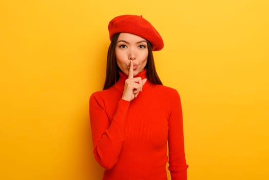 Woman indicates with the hand to be quite.