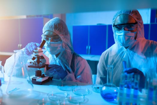 Researcher studies new treatments under the microscope