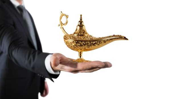 Businessman hold a genie lamp of aladdin. concept of desire