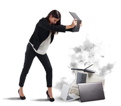 Stressed businesswoman furiously attacking computers and laptops