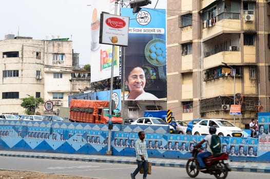 Political hoarding of Mamata Banerjee Trinamool Congress supreme showing Bangla Nijer Meye kei Chay (Bengal wants its own daughter ) in city street of Kolkata West Bengal India 17 April 2021