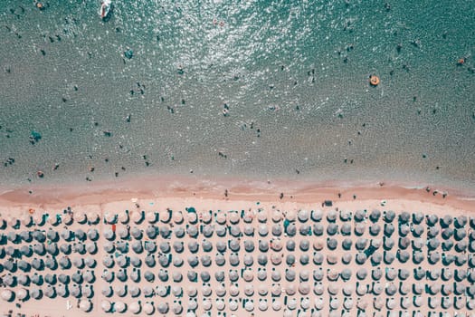 Aerial view of amazing beach with umbrellas and turquoise sea in Greece. Travel concept.