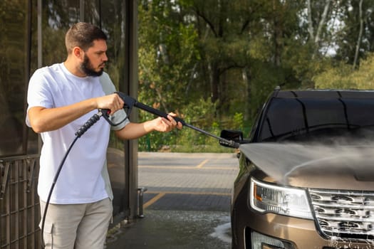 He loves his car. Man washing car. High quality photo
