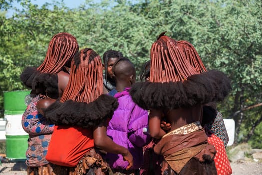NAMIBIA, OMUSATI REGION, MAY 7: Group of young Himba woman with traditional hairstyle and red clay painted bodies. The Himba are indigenous namibian ethnic people, in northern Namibia, May 7, 2018, Namibia