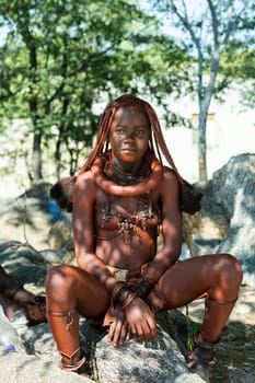 NAMIBIA, OMUSATI REGION, MAY 7: Portrait of Himba woman with traditional hairstyle and necklaces around her neck. The Himba are indigenous namibian ethnic people, in northern Namibia, May 7, 2018, Namibia