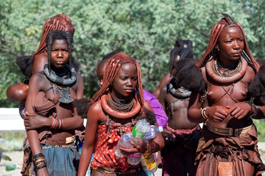 NAMIBIA, OMUSATI REGION, MAY 7: Group of young Himba woman with traditional hairstyle and red clay painted bodies. The Himba are indigenous namibian ethnic people, in northern Namibia, May 7, 2018, Namibia