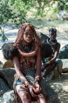 NAMIBIA, OMUSATI REGION, MAY 7: Portrait of Himba woman with traditional hairstyle and necklaces around her neck. The Himba are indigenous namibian ethnic people, in northern Namibia, May 7, 2018, Namibia
