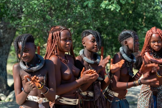NAMIBIA, OMUSATI REGION, MAY 7: Group of young Himba woman with traditional hairstyle and red clay painted bodies. The Himba are indigenous namibian ethnic people, in northern Namibia, May 7, 2018, Namibia