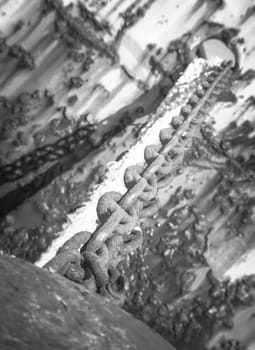 Rusty brown chain. Close up of a rust brown chain of a abandoned boat.