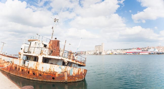Shipwreck at the pier. harbor of Cagliari - Sardinia.
