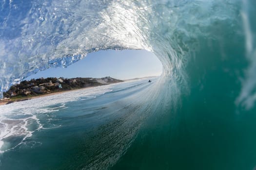 Wave hollow crashing inside ocean water view surfing tube ride.