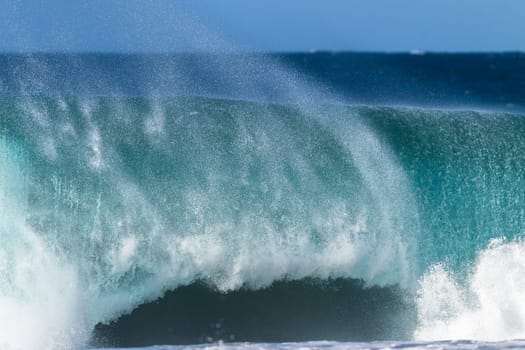 Ocean large wave swell crashing hollow water energy power of nature on coastline beach.
