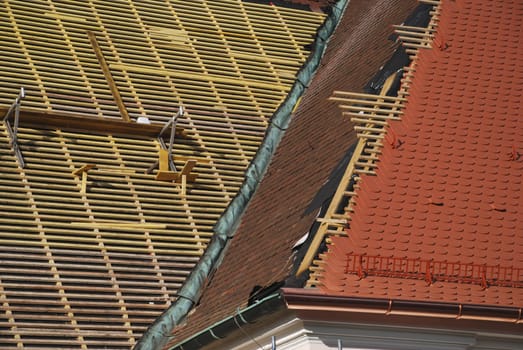 A pitched roof is covered with plain tiles. You can see the substructure of the roof with the roof battens
