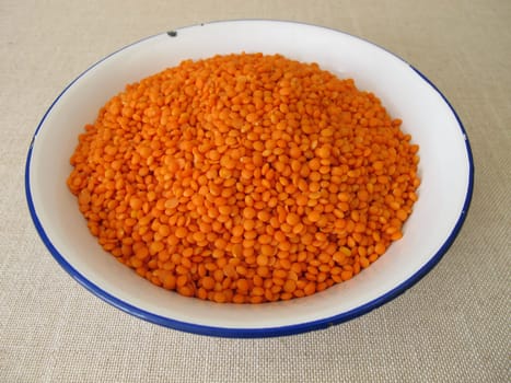Hand bath with red lentils in a bowl