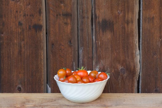 Delicious fresh and juicy vegetables from farming agriculture. Organic nature solanum tomato food on wooden background with copyspace.