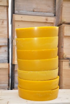 Round wax blocks in front of beehives in beekeeping