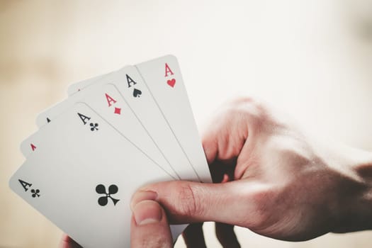 Young man is playing cards, cutout of his hands