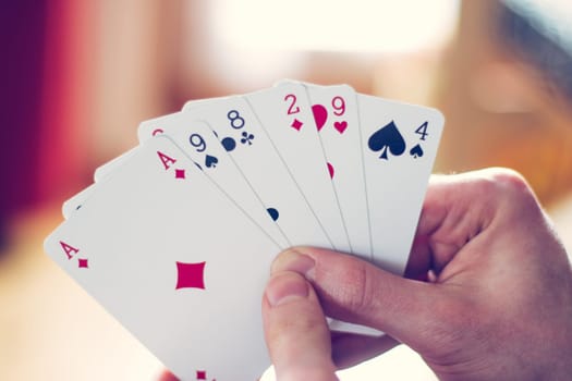 Young man is playing cards, cutout of his hands