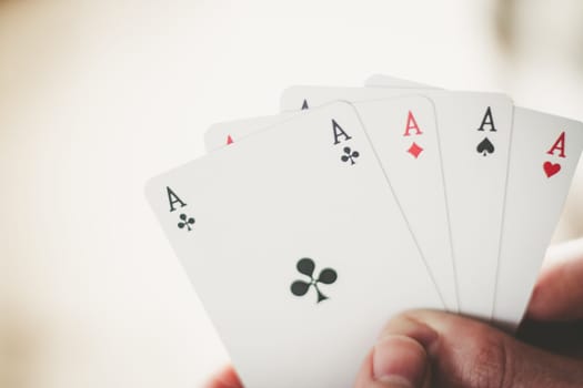 Young man is playing cards, cutout of his hands