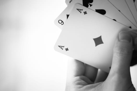 Young man is playing cards, cutout of his hands