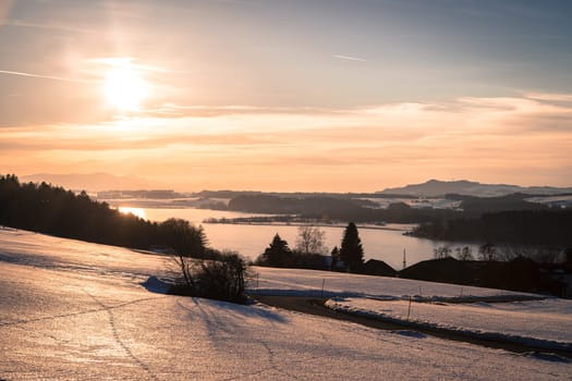 Lake, snowy fields and sundown: scenery at Wallersee, Austria