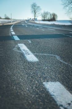 Black rough asphalt road in Austria, closeup
