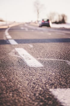 Black rough asphalt road in Austria, closeup
