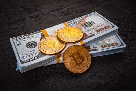 golden bitcoin metal coin on one US dollar bill