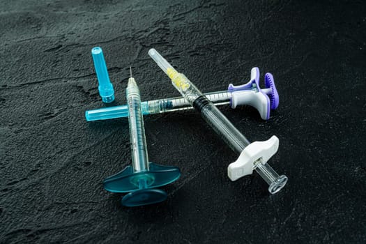Medical injection syringes with solution on black background
