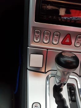 A look inside the interior of a sports car photographed on a public street.