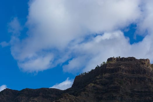 Mountains on the coast between Puerto de Mogan and Puerto Rico. Layers of volcanic rock.