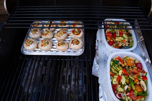 Grilled vegetables ( colorful bell pepper, zucchini, eggplant ) with basil and dry herbs on a plate over dark slate, stone, concrete or metal background.Top view.