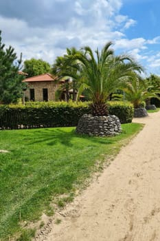 Park palm garden with Mediterranean villa