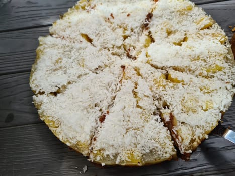 Homemade round sponge cake or chiffon cake on white plate so soft and delicious with ingredients: eggs, flour, milk on wood table. Homemade bakery concept for background and wallpaper.