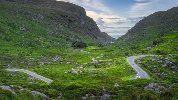 Beautiful landscape with winding narrow road running through Gap of Dunloe and Black Valley, MacGillycuddys Reeks mountains, Ring of Kerry, Ireland