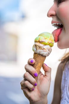 Young girl enjoys ice cream in the summer, blurry