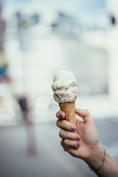 Woman holds ice in her hand, beautiful summer day