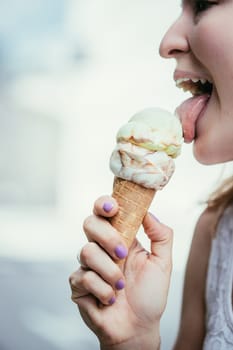 Young girl enjoys ice cream in the summer, blurry