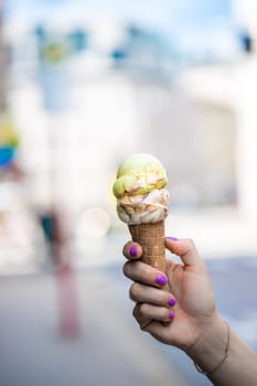 Woman holds ice in her hand, beautiful summer day