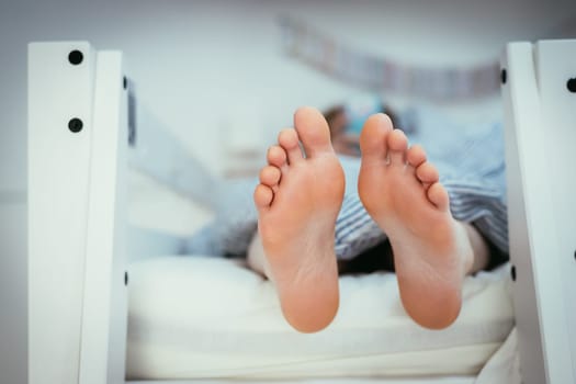 Girl with Barenaked feed is lying in her bunk bed, morning