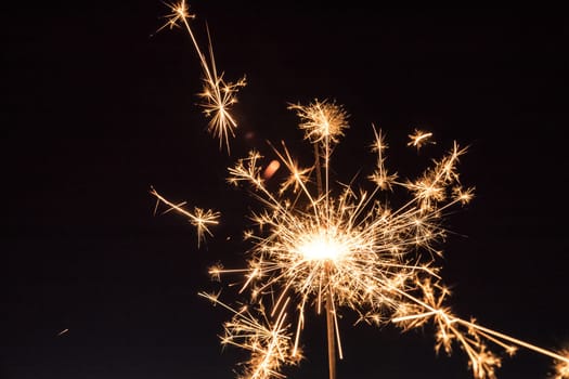 Christmas sparkler on black background. Sparks.