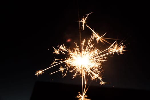 Christmas sparkler on black background. Sparks.