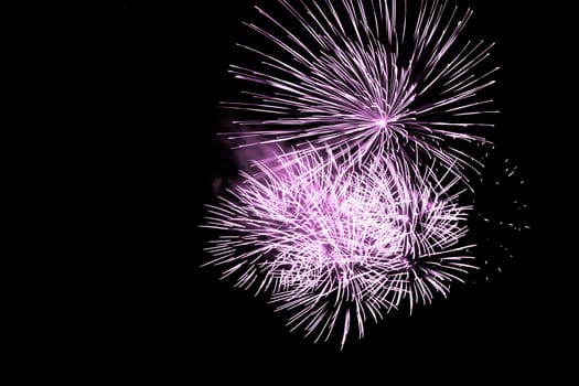 Premium entertainment magic star firework at e.g. New Years Eve or Independence Day party celebration. Black dark night background.