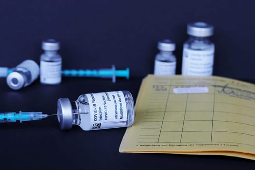 Corona Covid-19 vaccination with vaccination card, vaccination bottles and syringes