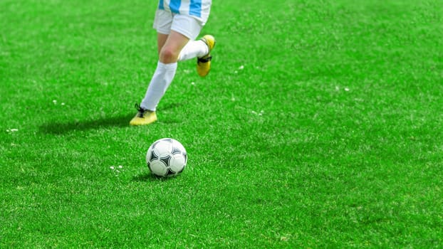 Football Player Compete For a Ball. Children Playing Sports on Grass Pitch. Closeup Image of Youth Football Competition Match. detail photo