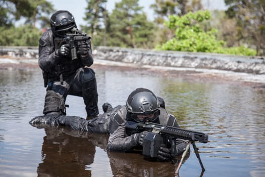 Spec ops police officers SWAT in action in the water