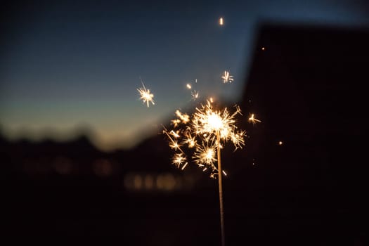 Christmas sparkler on black background. Sparks.