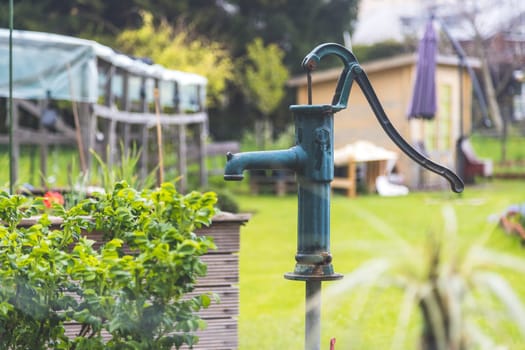 Close up of well for watering urban gardening vegetable patches.